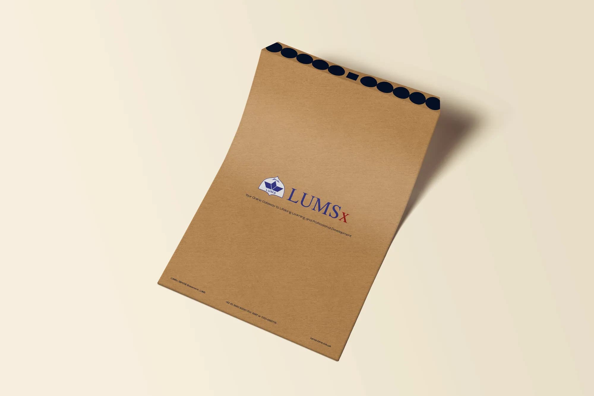 A kraft LUMSx envelope with the logo, on cream