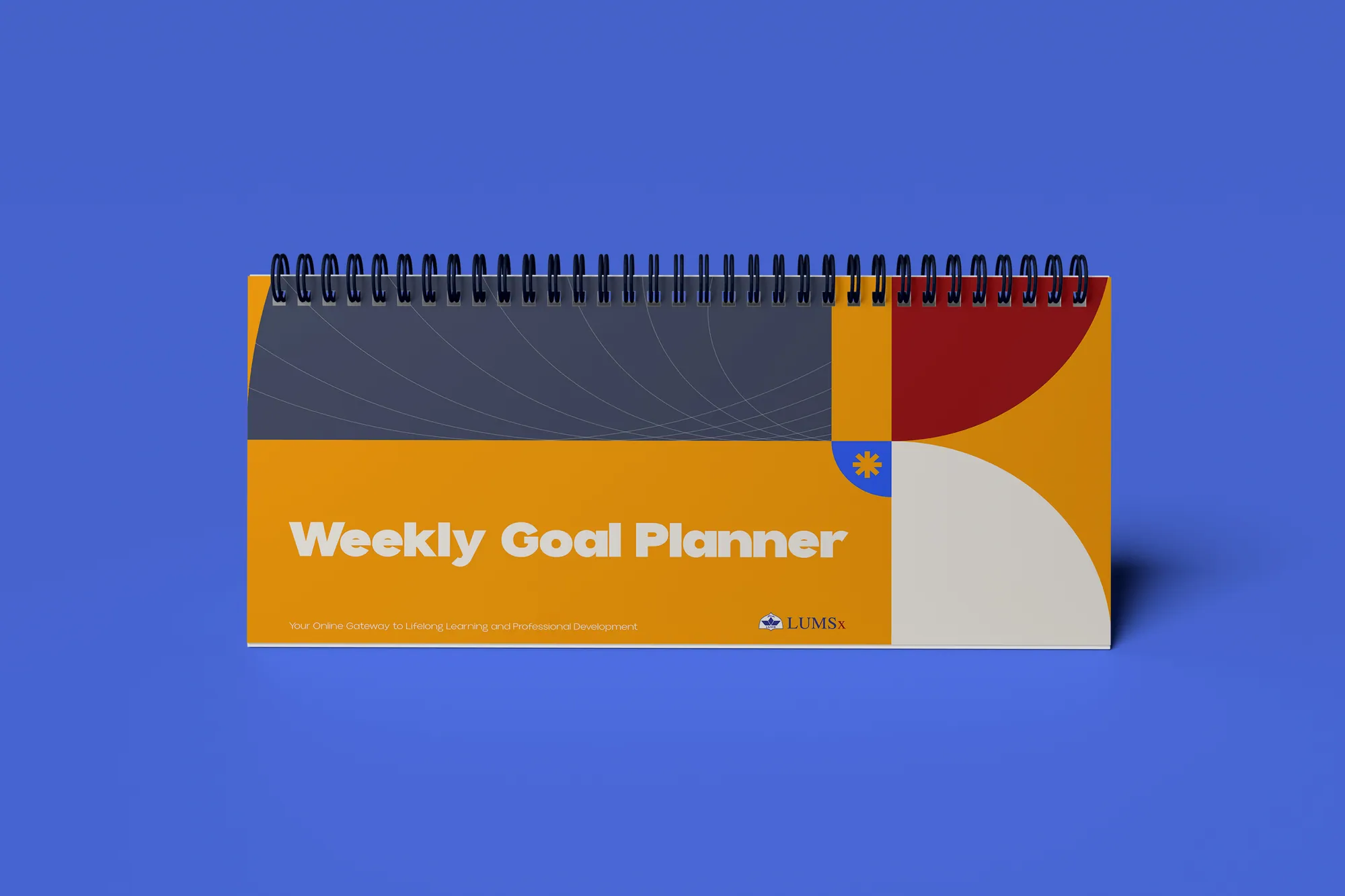 A LUMSx desk planner titled “Weekly Goal Planner” in marigold, red and navy